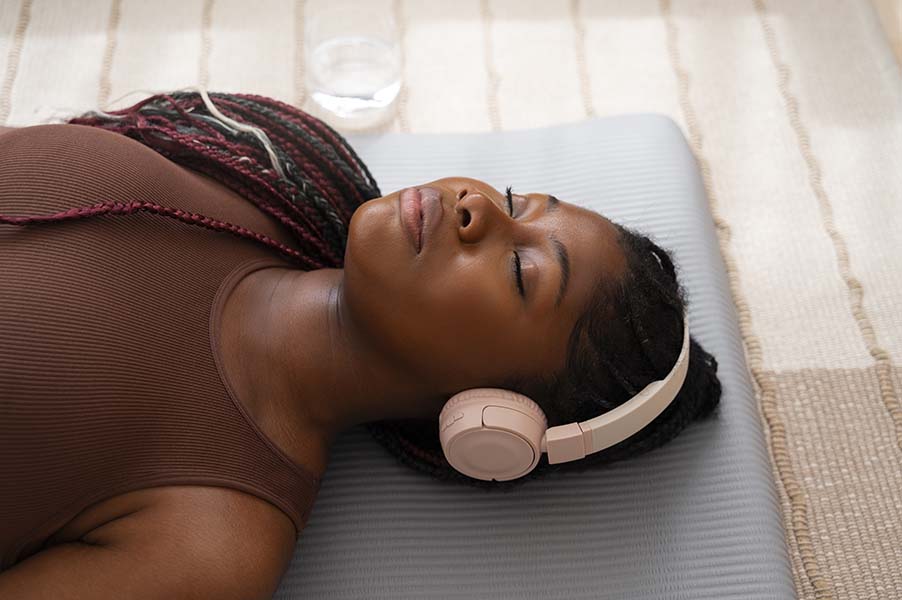 African woman practicing breathwork outdoors in nature