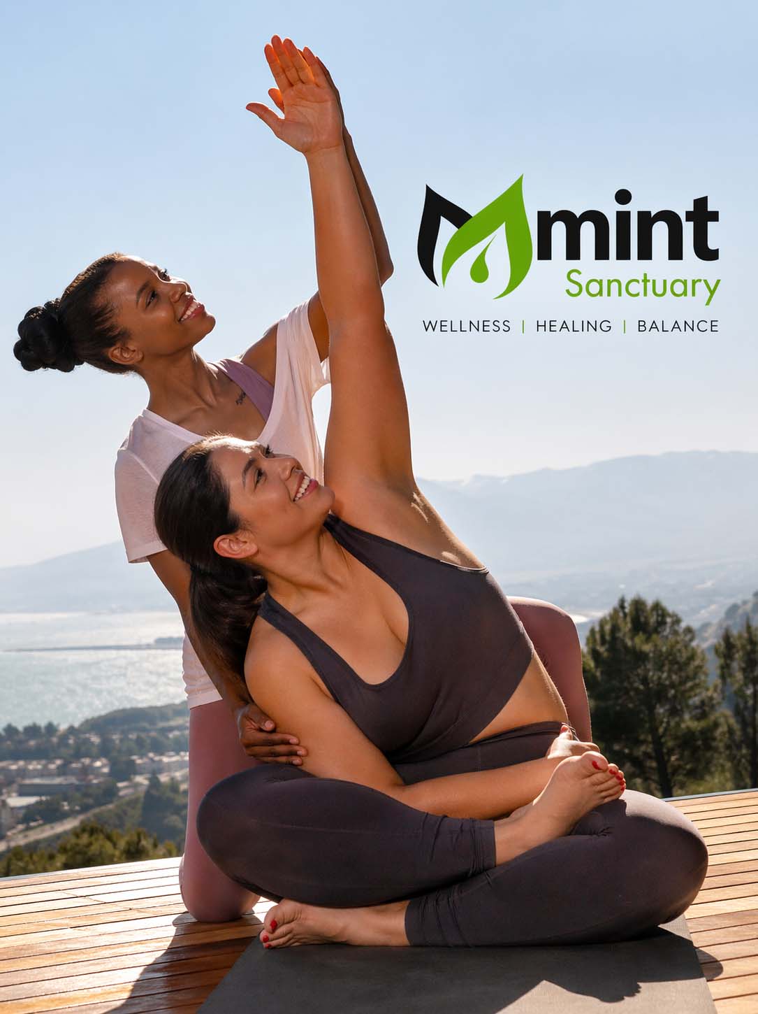 Two women practicing assisted yoga stretch outdoors with Mint Sanctuary wellness branding, promoting balance, healing, and mindful movement